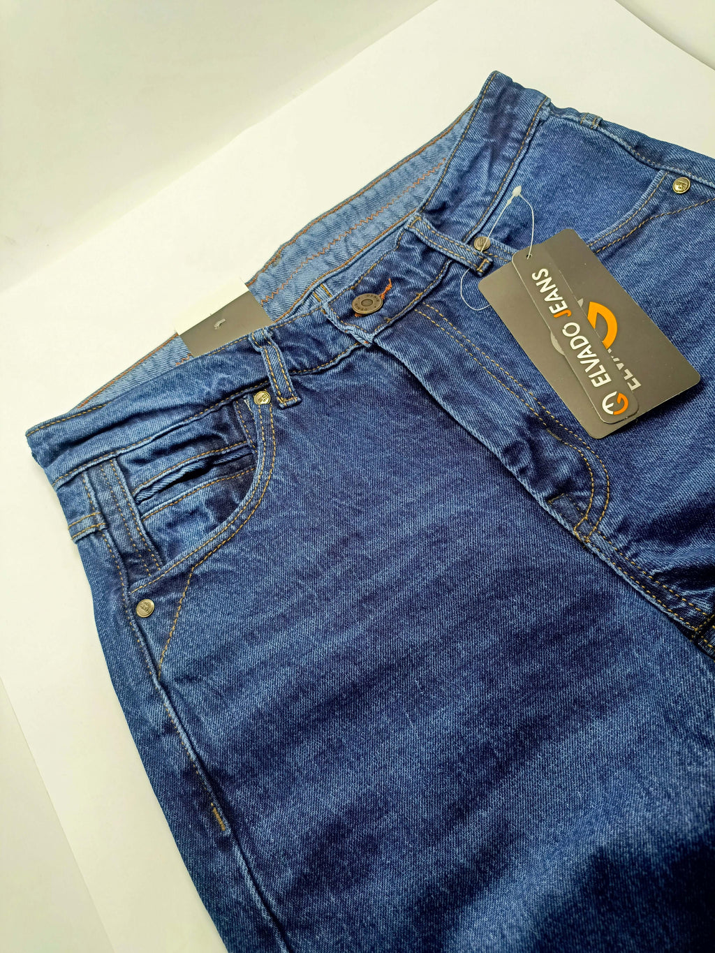 Dark Blue Denim close-up view of ELVADO JEANS with tags showcasing premium slim fit and stretchy cotton jeans.