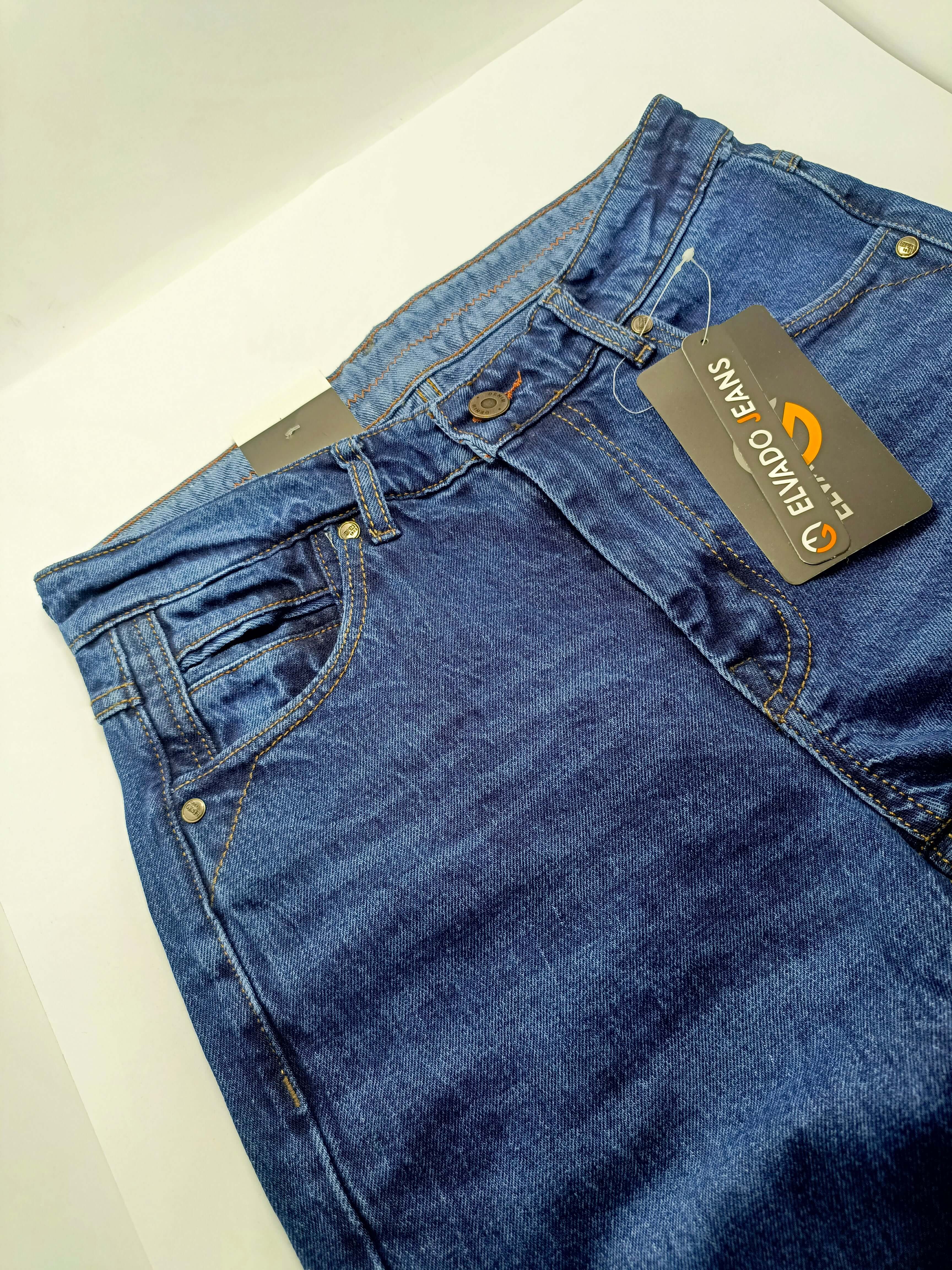 Dark Blue Denim close-up view of ELVADO JEANS with tags showcasing premium slim fit and stretchy cotton jeans.