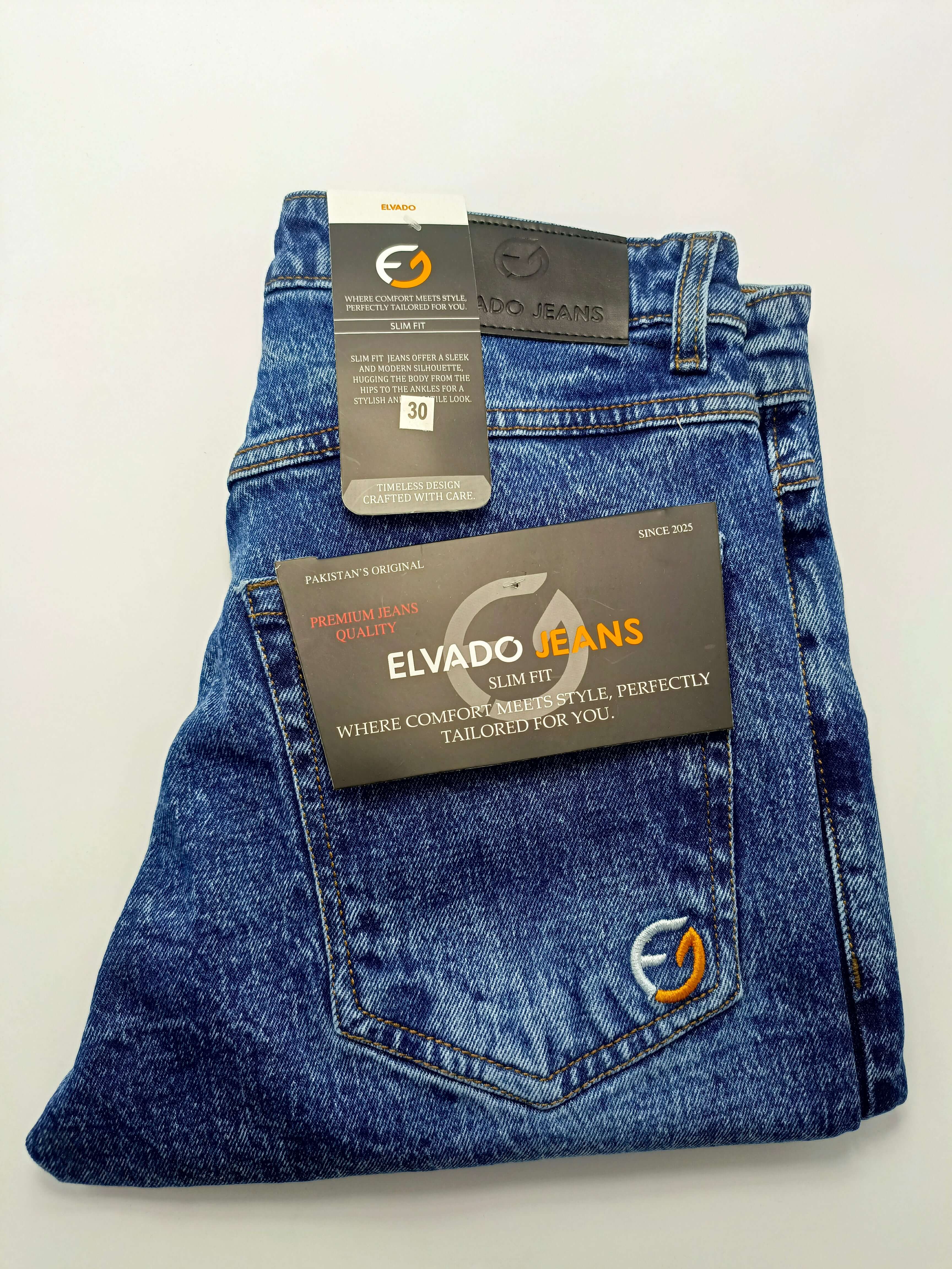Dark indigo acid wash Elvado Jeans with tags, showcasing slim fit and premium quality cotton denim.
